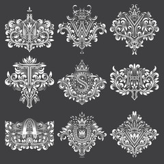 Set of ornamental monogram in coats of arms form. White floral decorations on black. Isolated tattoos in vintage baroque style.