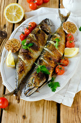 Mackerel baked with lemon, garlic and tomatoes