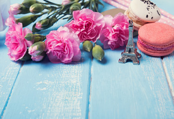 Flowers, french macaron and souvenir eiffel tower
