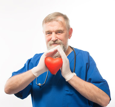 Doctor holding a red heart in the hands