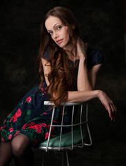 beautiful young woman in a dress. Studio, black background.