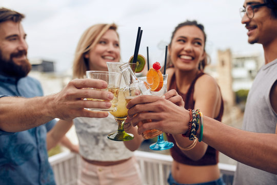 Friends Toasting Cocktails At A Party