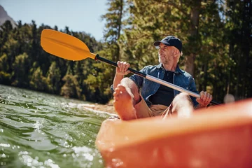 Foto op Canvas Mature man paddling a kayak © Jacob Lund