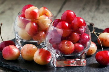 Red and yellow sweet cherries in a glass bowl, selective focus