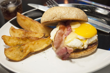 Hamburger with fried eggs , bacon and potato fried