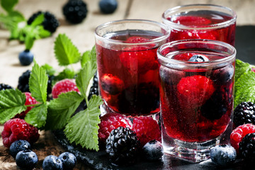 Cold summer berry tea with raspberries, blueberries, blackberrie
