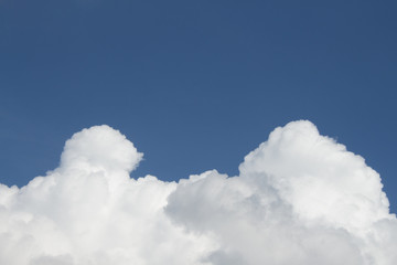 White puffy clouds on the background blue sky