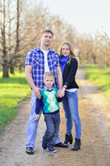 Fototapeta premium happy family, mother, father and son are building on a rural roa