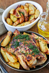 Whole roasted chicken with potatoes on dinner table
