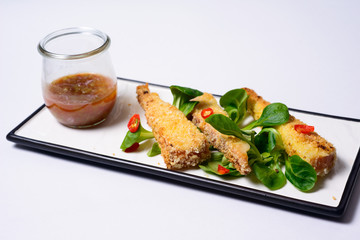 fried mozzarella sticks tomato sauce served with greens