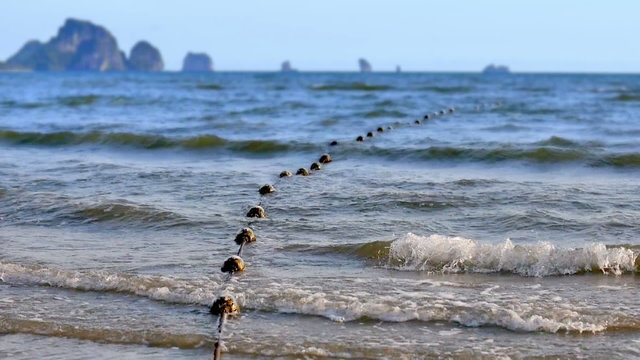 Old buoys in the sea near coastline, Ao Nang, Krabi, Thailand.
