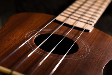 Fototapeta premium Close up of ukulele on wooden background.