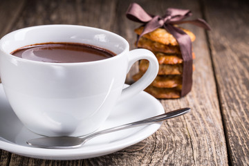 Hot chocolate with homemade oat cookies in satin ribbon.