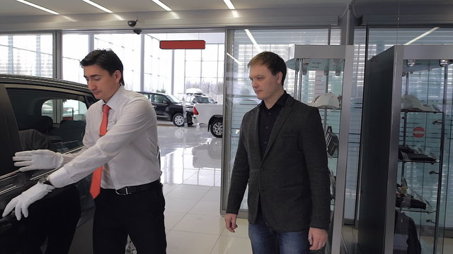Image of car dealer with client preparing to test drive