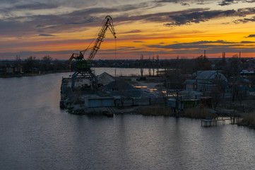 Fototapeta premium Evening landscape with small cargo port on Samara river in Novomoskovsk city, Ukraine