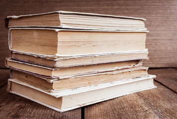 Fototapeta premium Stack of old books on wooden background