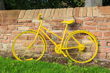 Fototapeta premium Yellow Bicycle. One of a number of yellow bicycles lining the route of the 2015 Tour of Britain cycle race through the Eden Valley in Cumbria, England.