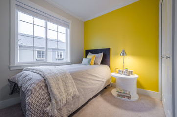 Fototapeta na wymiar Modern yellow bedroom interior in a luxury house