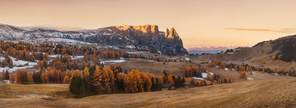 Italy. Dolomites. Autumn landscape with bright colors, house and larch trees in the soft sunlight.