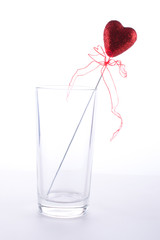 red heart in a cup on a white background