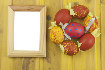 Colorful Easter eggs on an old yellow wooden background. Celebrating Easter holidays. Place for your text. Symbol of Easter.

