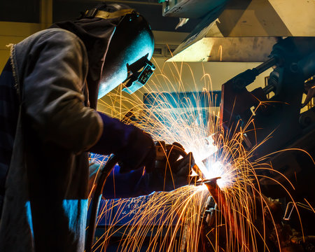 welding worker in the automotive part in factory
