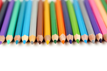 Fototapeta premium Drawing colourful pencils on a white background, close up