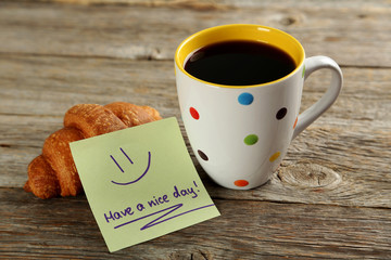 Piece of note paper on grey wooden background