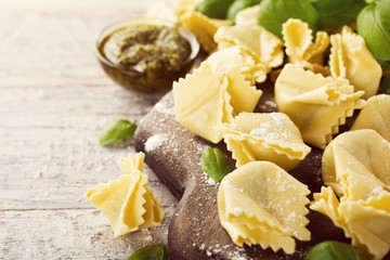 Homemade raw Italian saccottini with green pesto