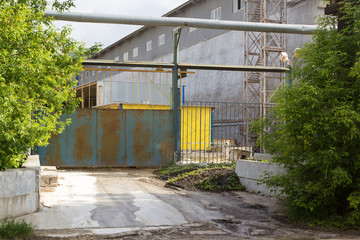 Naklejka na ściany i meble old metal gate at entrance to the plant