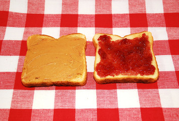 Peanut butter and jelly toast on a checkered tablecloth