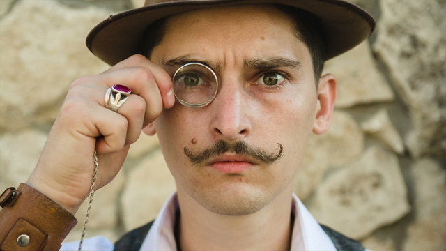 man looking through a monocle