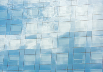 blue sky and clouds reflected in office building
