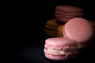Pink Macarons Stacked with Dark Back Ground and Copy Space