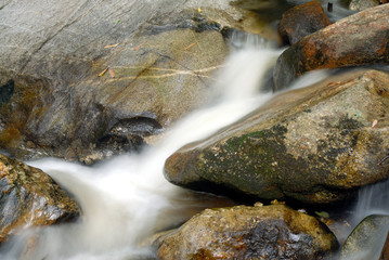 Naklejka na ściany i meble closeup of water flow among stones