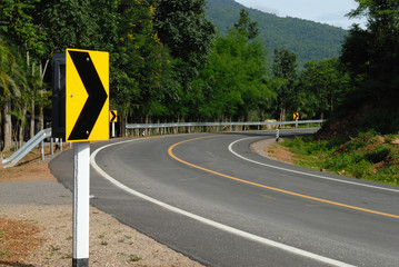road signs warn for ahead dangerous curve