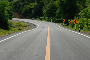 road signs warn for ahead dangerous curve