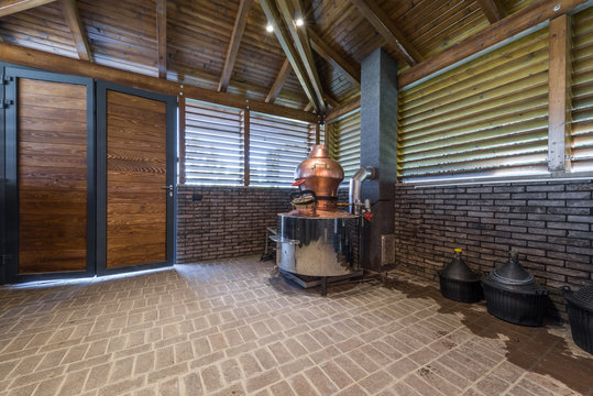 Cauldron for brandy in modern log cabin interior