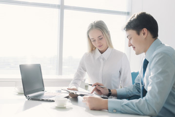 Obraz premium Two colleagues discussing a business project, a man and a woman