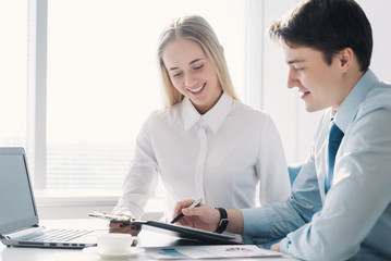 Two colleagues discussing a business project, a man and a woman