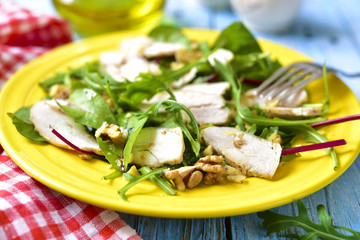 Chicken salad with salad mix and walnuts.