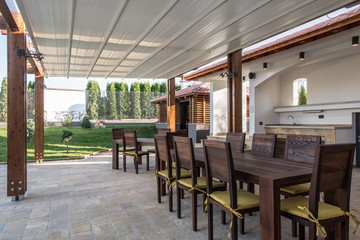 Wooden table and chairs on open terrace 