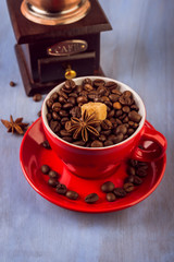 coffee beans, wooden coffee grinder and coffee cup.