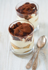 tiramisu in glass on wooden surface