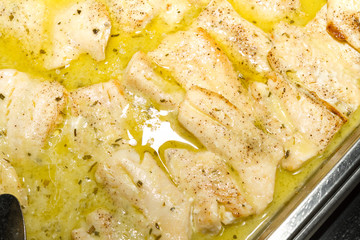 Oven baked haddock fish portions.
