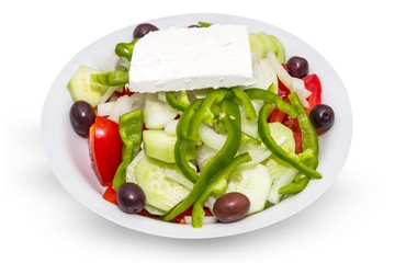 Plate of real Greek salad isolated on white.