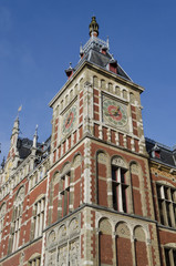 close up detail of clock tower on a red brick and sandstone building