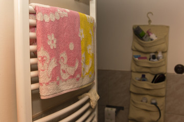 pink towel dried on the ladder heating