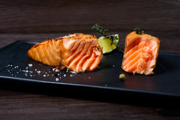 salmon steak served with potatoes and lime