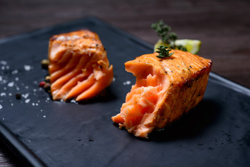 salmon steak served with potatoes and lime